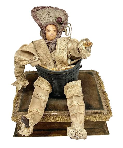 Modern reproduction automaton in the form of a baby doll in a basket ...