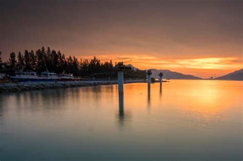 Premium Photo | Boat in harbor at sunset