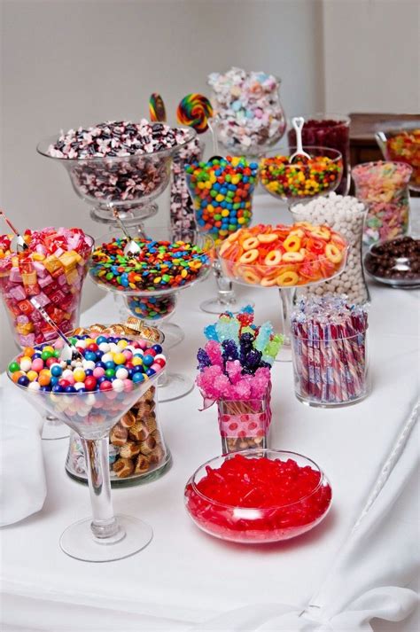 a table topped with lots of different types of candy and candies on top ...