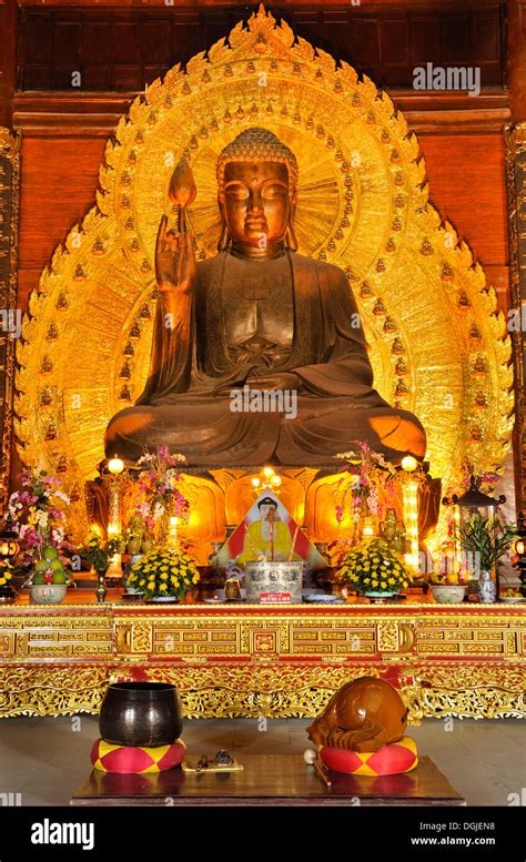 Golden Buddha statue at the construction site of the Chua Bai Dinh ...