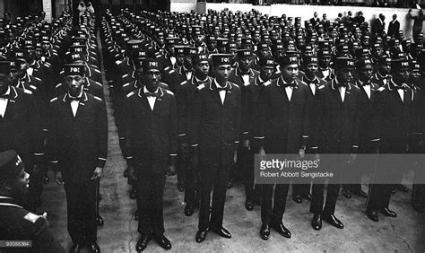 Uniformed men in the uniform of the Fruit of Islam, a subset of the ...