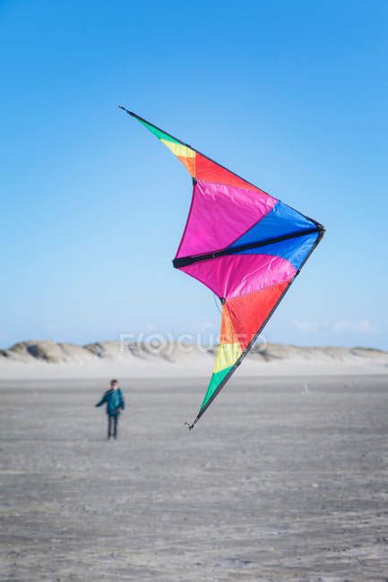 Boy flying kite on beach — child, 12 to 13 years - Stock Photo | #166080566