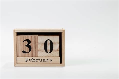 Premium Photo | Wooden calendar february 30 on a white background