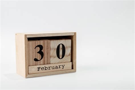 Premium Photo | Wooden calendar february 30 on a white background