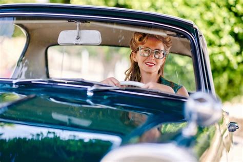 Premium Photo | Smiling woman driving vintage car