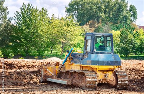 Dozer at construction site, earth works, heavy duty bulldozer leveling ...