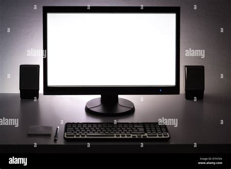 Blank white pc monitor on desktop in organized workplace Stock Photo ...