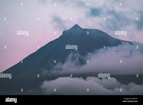 Mount Pico volcano western slope viewed from ocean during full moon ...