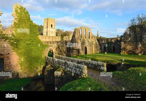 The ruins of Fountains Abbey on a fine autumn morning as viewed from ...