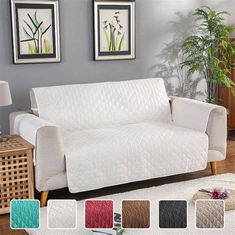 a white couch sitting on top of a wooden floor