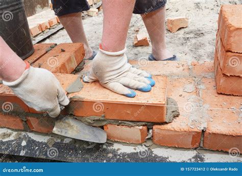 Bricklayer Using a Trowel To Lay New Red Brick House Wall Outdoor ...