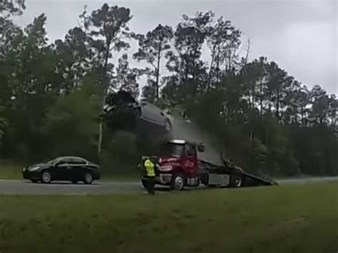 Video: A driver's car soared 120 feet after vaulting off of a tow truck ...