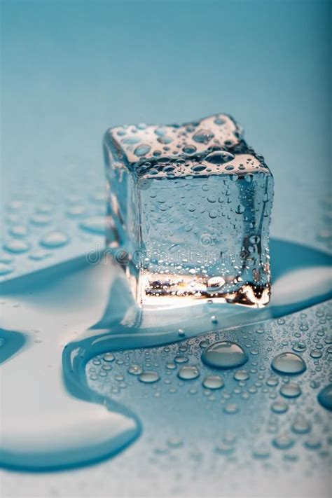 Ice Cube with Water Drops on a Blue Background. the Ice is Melting ...