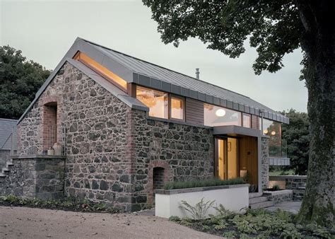 Traditional stone barn updated with a steel-framed living space ...