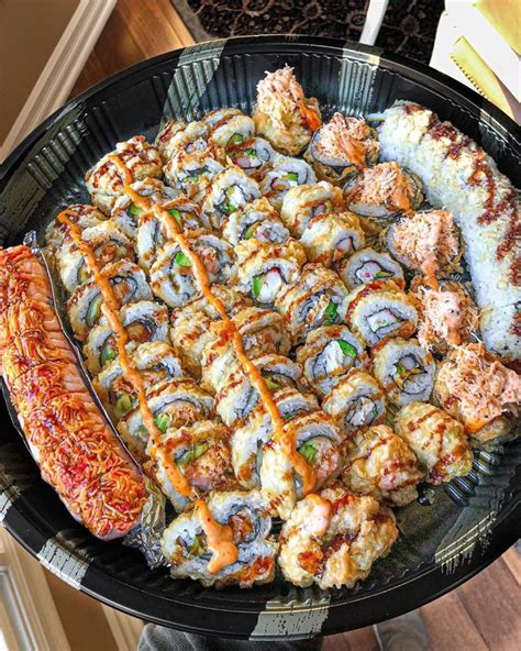 a platter filled with lots of different types of sushi and other food items