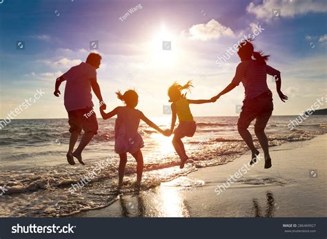 Happy Family Jumping Together On Beach Stock Photo 286469927 | Shutterstock