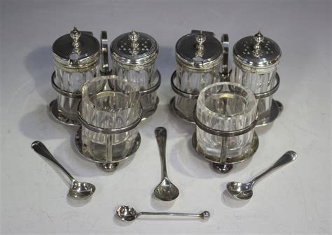 A pair of late Victorian silver trefoil shaped three-piece condiment ...