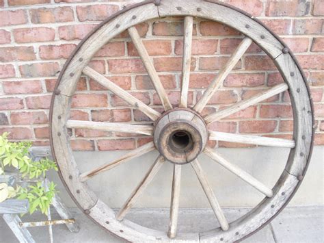 Just a bed of Roses: Antique wagon wheel $150.00