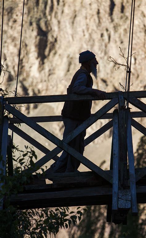 An old wooden bridge across a tributary of the Shyok River in Ladakh ...