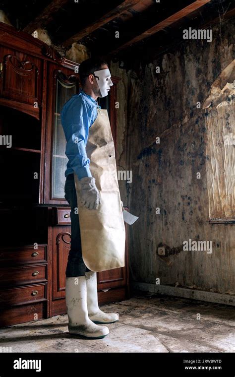 Anonymous terrifying man in butcher costume with apron and knife ...