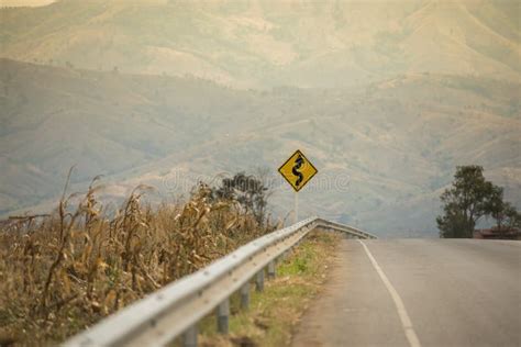 Winding Road Sign on Asphalt Road Stock Photo - Image of curvaceous ...