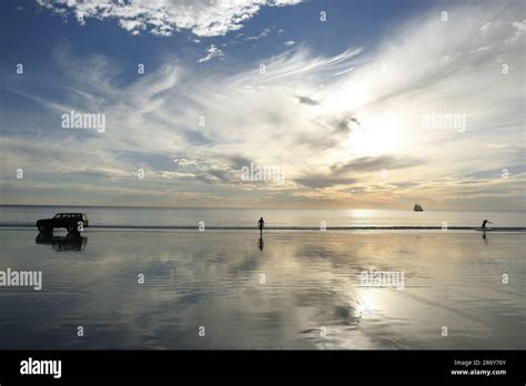 Boy enjoying car surfing at Broome Cable Beach Stock Photo - Alamy