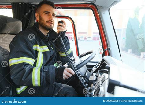 Firefighter Using Radio Set while Driving Fire Truck Stock Photo ...