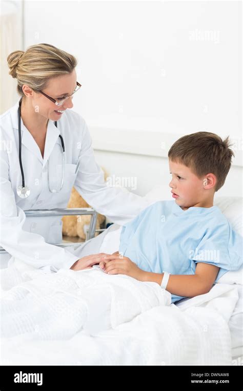 Doctor comforting sick boy in hospital Stock Photo - Alamy