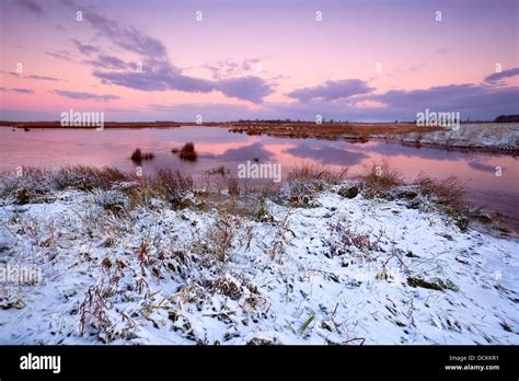 snow by lake at sunrise Stock Photo - Alamy