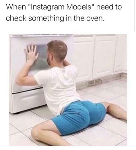 a man sitting on the floor in front of an oven with his hand up to it