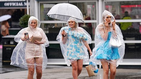 'Bring a brolly!' Racegoers brave the rain on Aintree's Ladies Day | UK ...