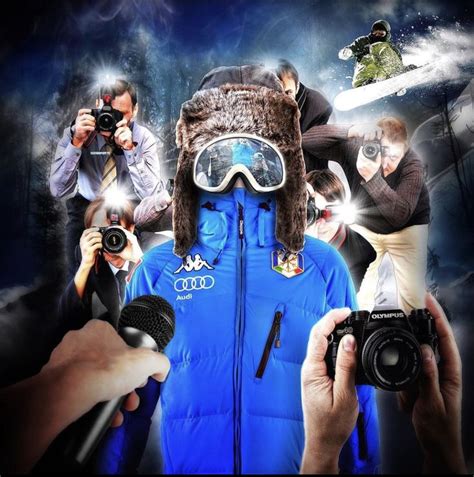 a person with ski goggles and snowboarding gear holding a camera in ...