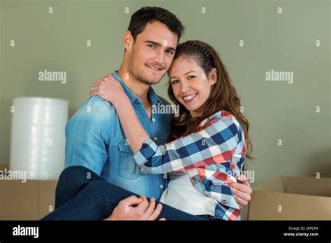 Man lifting woman in his arms Stock Photo - Alamy