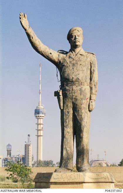 A statue of Saddam Hussein in central Baghdad is battered but still ...