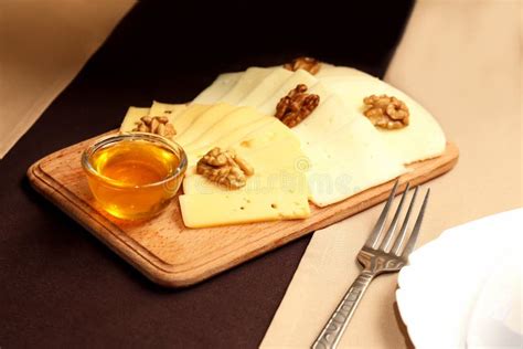 Sliced Pieces of Cheese with Nuts on Wooden Tray Stock Image - Image of ...