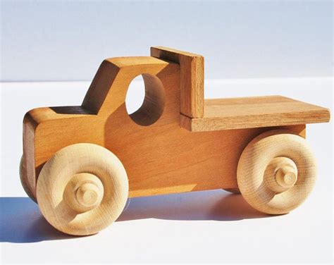 a wooden toy truck sitting on top of a white table