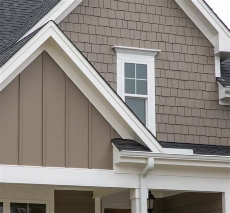 a gray house with white trim and windows