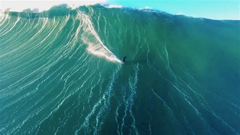 Drone video of surfer riding giant wave in Nazaré, Portugal