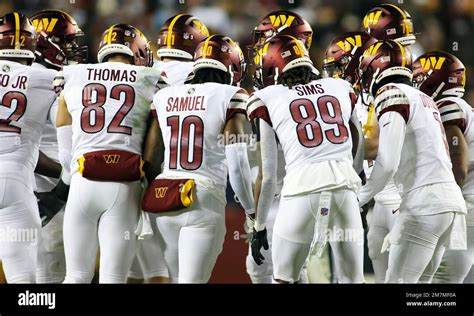 Washington Commanders players huddle up during an NFL football game ...