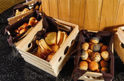 A buffet table with variety of bread in the wooden baskets 13285382 ...