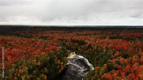 Beautiful pull out rising up aerial view of Tahquamenon falls waterfall ...