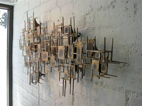 A brass mid century modern wall sculpture. Description from 1stdibs.com ...