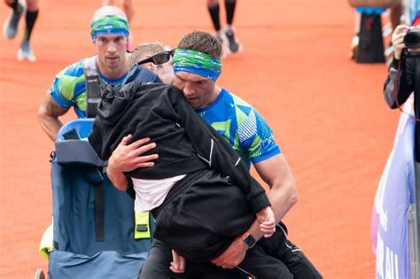 Kevin Sinfield carries Rob Burrow over finish line in Leeds Marathon