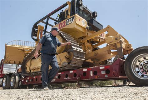 These bulldozers are firefighters, too, plowing through dirt and danger ...