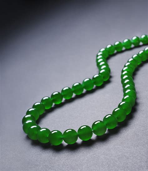 AN EXTREMELY RARE AND EXCEPTIONAL “IMPERIAL GREEN” JADEITE BEAD AND ...