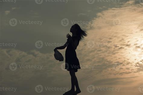 Silhouette sad girl at sunset. 13310633 Stock Photo at Vecteezy