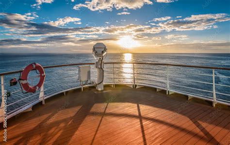 Wooden deck and railing from cruise ship. Beautiful sunset and ocean ...