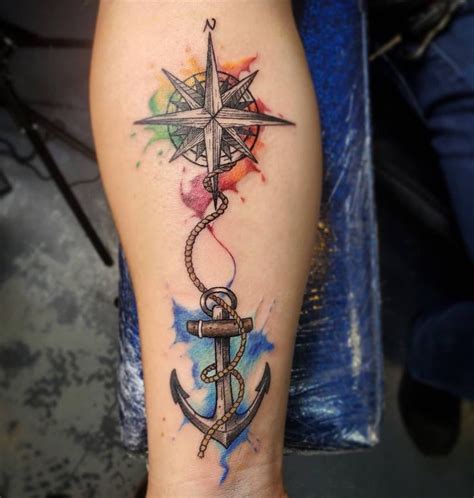 an anchor with a compass tattoo on the side of his leg and watercolor ...