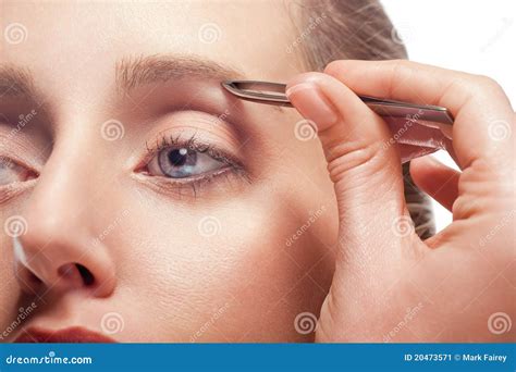 Woman plucking eyebrow stock image. Image of face, background - 20473571