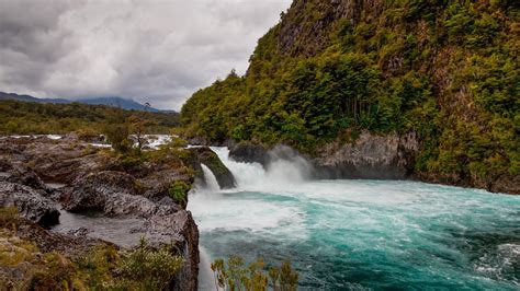 River Petrohué Waterfalls with rock formations and Osorno Volcano in ...